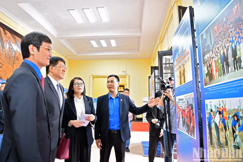 Делегаты посещают фотовыставку, посвященную обмену и сотрудничеству между комсомольцами и молодыми людьми двух стран.