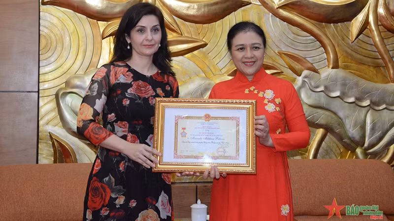 Председатель СОДВ Нгуен Фыонг Нга (справа) вручает памятную медаль Послу Болгарии во Вьетнаме Маринеле Петковой. Фото: qdnd.vn