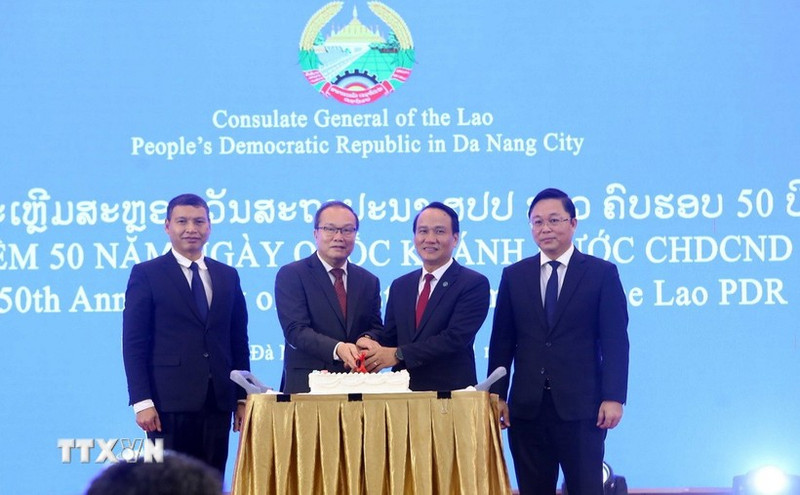 Генеральный консул Лаоса в Дананге Супхань Хадаохеуанг, Постоянный заместитель секретаря Парткома г. Дананга Нгуен Динь Винь и делегаты разрезают праздничный торт. (Фото: ВИА)