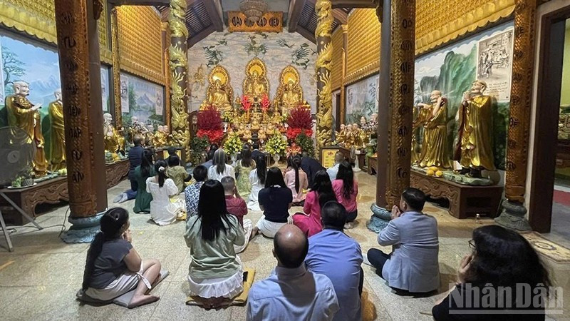 Представители вьетнамской общины в Лаосе с благоговением возносят молитвы о мирном и счастливом новом годе. (Фото: Зюи Тоан)