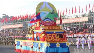 Колонна участников парада с эмблемой 50-летия Национального праздника Лаоса на генеральной репетиции парада и шествия, посвященного празднованию 50-летия основания Лаосской Народно-Демократической Республики (2 декабря 1975 г. – 2 декабря 2025 г.).