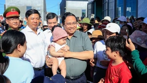 Премьер-министр Фам Минь Тьинь посещает жителей зоны переселения Куангдык в общине Тюианнам провинции Даклак. Фото: VGP 