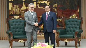 Премьер-министр Фам Минь Тьинь и Министр иностранных дел Лаоса Тхонгсаван Фомвихан. Фото: Чан Хай