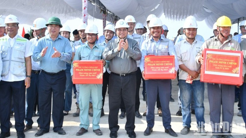 Премьер-министр Фам Минь Тьинь вручает подарки подразделениям, работающим на строительной площадке. Фото: Тхань Жанг