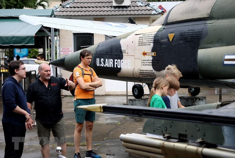 Иностранные посетители ознакомляются с американскими военными самолетами, участвовавшими в войне во Вьетнаме.