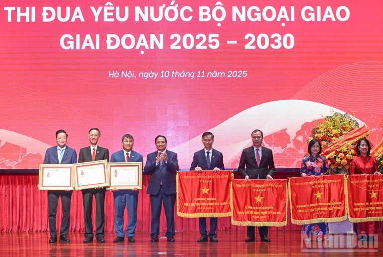 Премьер-министр Фам Минь Тьинь вручает Ордена Труда и флаги соревнований Правительства коллективам и отдельным сотрудникам Министерства иностранных дел за выдающиеся достижения. Фото: Чан Хай