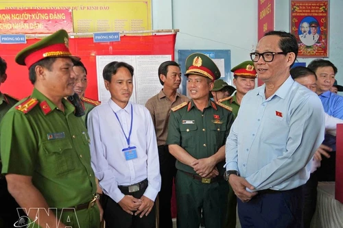 Заместитель председателя НС Чан Куанг Фыонг (справа) проверяет работу по организации выборов на избирательном участке № 1 (посёлок Кеньдао, коммуна Датмуй). (Фото: ВИА)