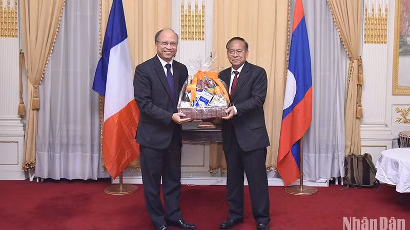 Посол Динь Тоан Тханг (слева) поздравляет Посла Лаоса во Франции с Национальным праздником. Фото: Кхай Хоан