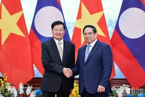 Премьер-министр Фам Минь Тьинь проводит встречу с Генеральным секретарём, Президентом Лаоса Тхонглуном Сисулитом. Фото: Чан Хай