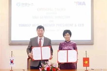 Генеральный директор ВИА Ву Вьет Чанг (справа) и президент, генеральный директор информационного агентства Йонхап Хван Дэ Ил подписывают протокол своих переговоров в Ханое 10 декабря. Фото: ВИA