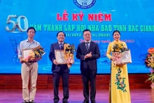 Товарищ Ле Куок Минь вручает похвальные грамоты представителям коллективов Ассоциации журналистов провинции Бакжанг.