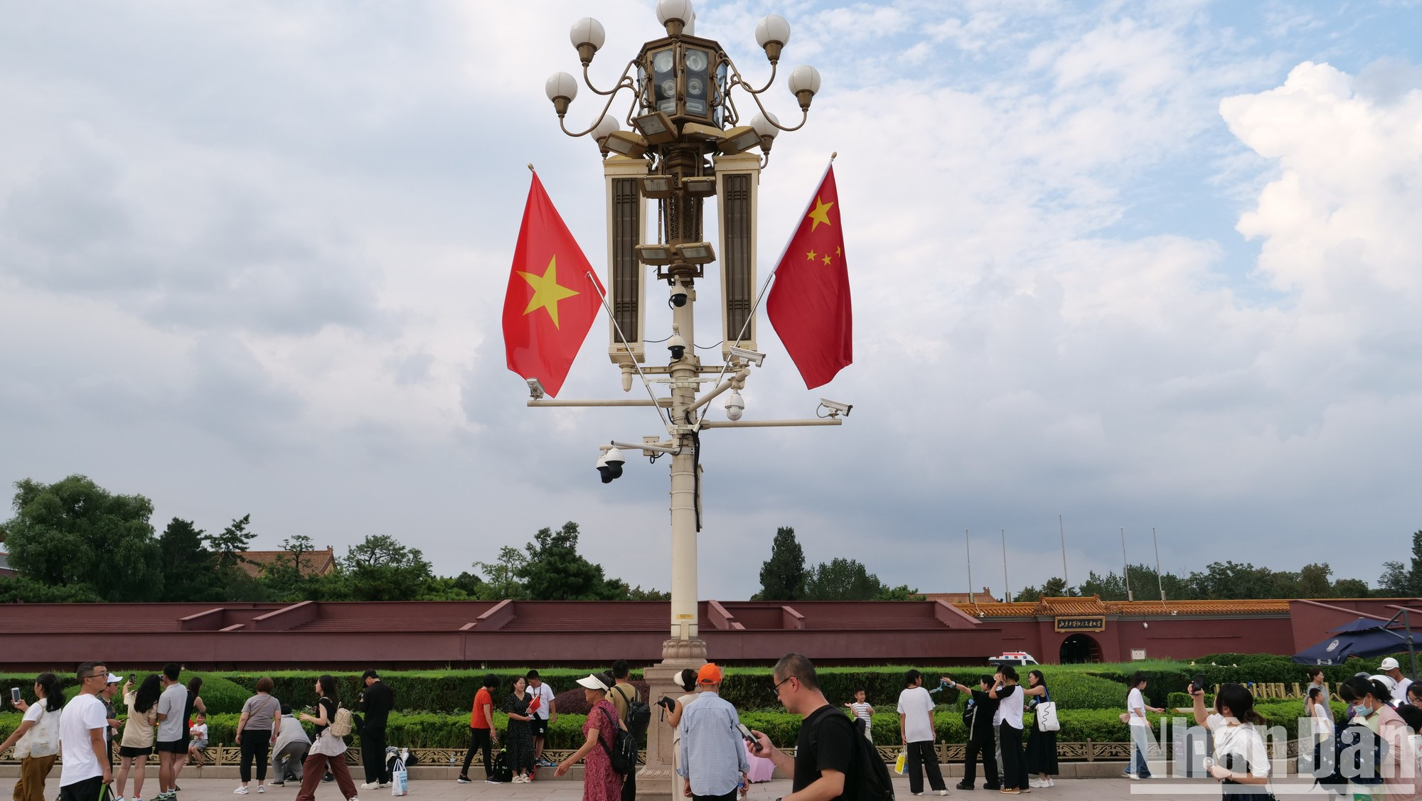 Перед Запретным городом развеваются национальные флаги Вьетнама и Китая.