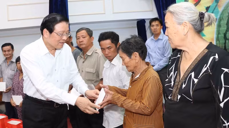Товарищ Фан Динь Чак вручает подарки семьям льготной категории в провинции Камау. Фото: ВИА