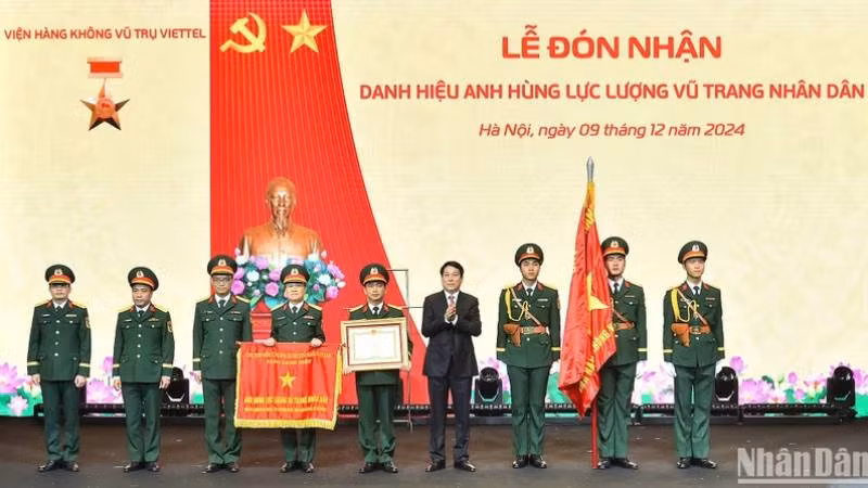 Президент Лыонг Кыонг вручает значок о присвоении звания «Герой народных вооруженных сил» Аэрокосмическому институту «Вьеттел». 