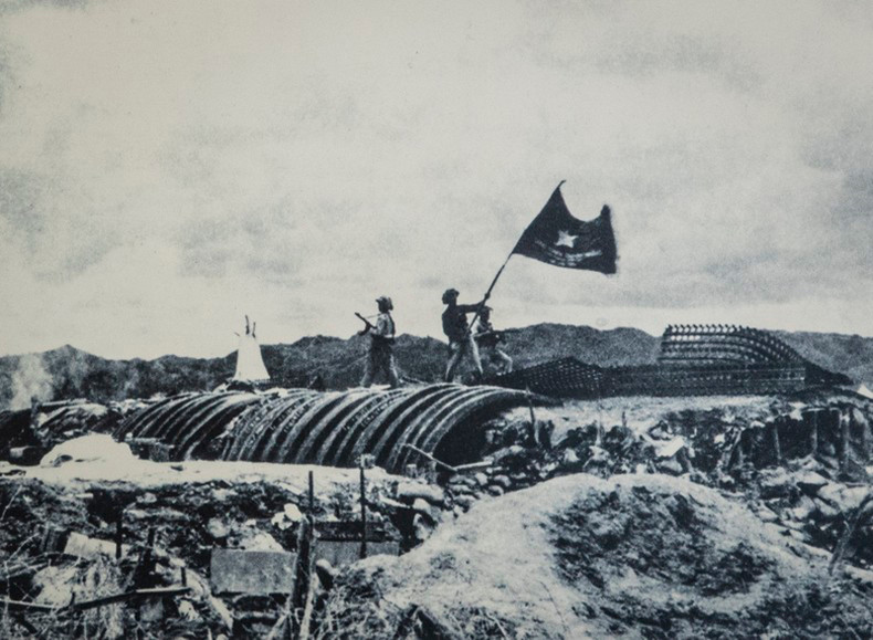 Флаг с надписью «С решимостью сражаться, с решимостью одержать полную победу» развевается на крыше бункера генерала Де Кастри, 7 мая 1954 года. Флаг с надписью «С решимостью сражаться, с решимостью одержать полную победу» развевается на крыше бункера генерала Де Кастри, 7 мая 1954 года.