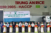 Делегаты разрезают ленту в знак экспорта первой партии риса с низким уровнем выбросов в Японию. 