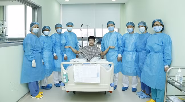 Врачи фотографируются с пациентом.