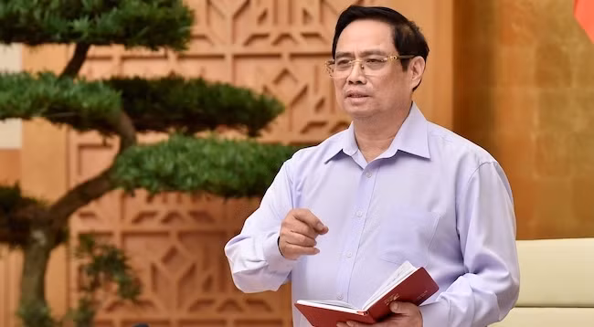 Премьер-министр Фам Минь Тьинь выступает на конференции. Фото: VGP