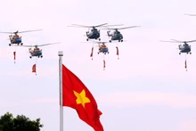 Выступление звена вертолетов Ми-171, Ми-17, Ми-8 с флагами Партии и Государства над районом площади Бадинь. Фото: ВИА