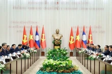 Генеральный секретарь ЦК КПВ То Лам и Генеральный секретарь ЦК НРПЛ, Президент Лаоса Тхонглун Сисулит председательствуют на встрече высокого уровня между КПВ и НРПЛ. Фото: ВИА