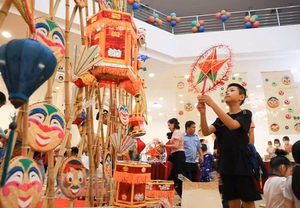 Дети своими руками делают традиционные игрушки. Фото: VNA