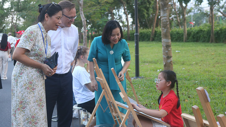 Делегаты разговаривают с участницей про выбранную ей тему. Фото: Т. Лам